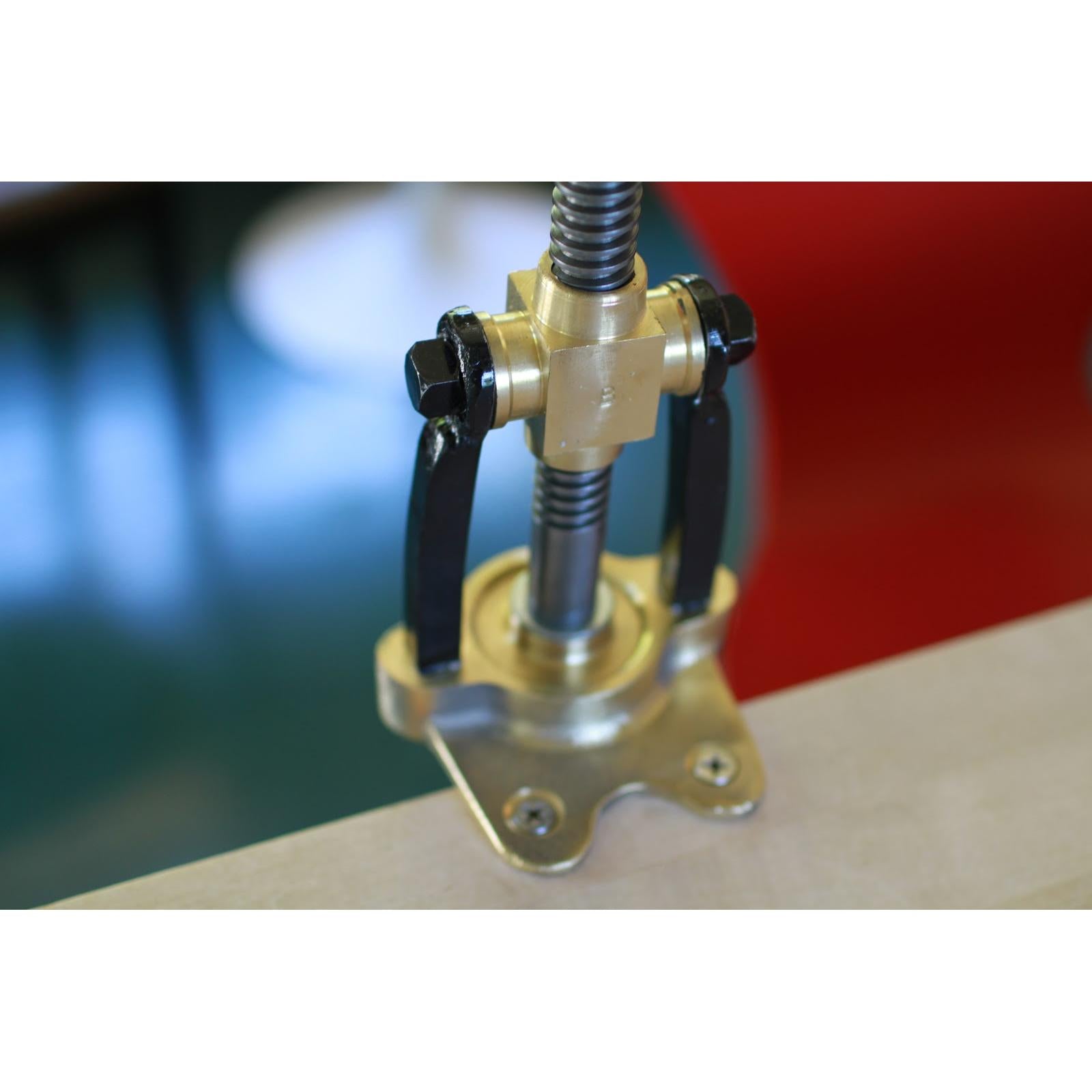 Bigolaro Premium Hand Pasta Extruder with Rigatoni and Spaghetti 2.5 mm Brass Dies Made in Italy on table with screws